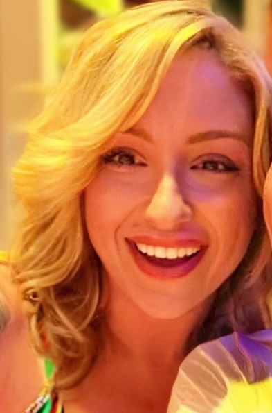 Carrie smiling in warm lighting